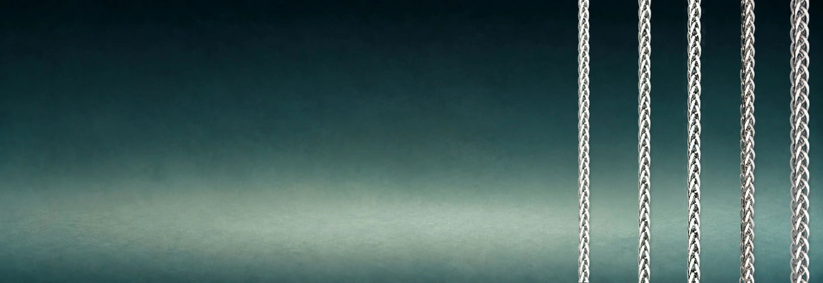 White gold wheat chains on a dark teal background