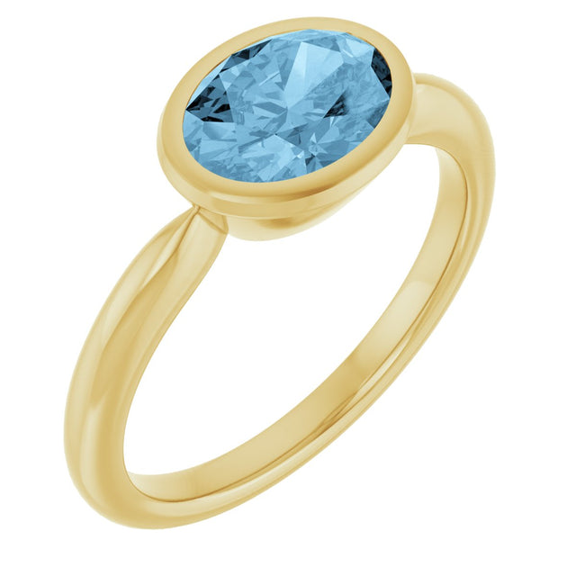 10K Gold Oval Natural Sky Blue Topaz Bezel-Set Solitaire Ring - Yellow Gold
