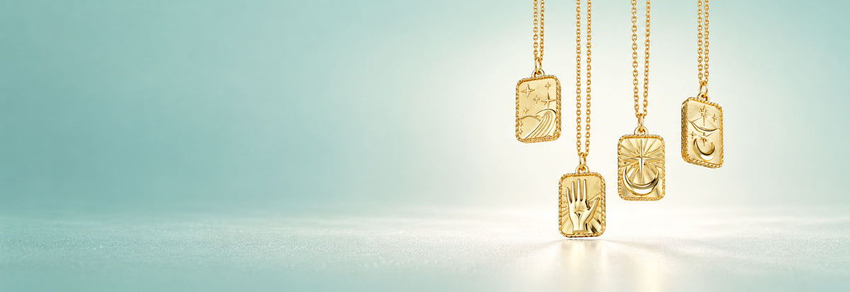 Yellow gold rectangular religious medal necklaces on a teal background