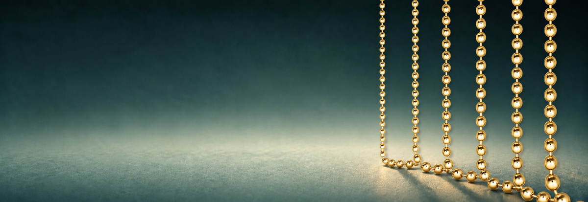 Yellow gold bead chains on a teal background