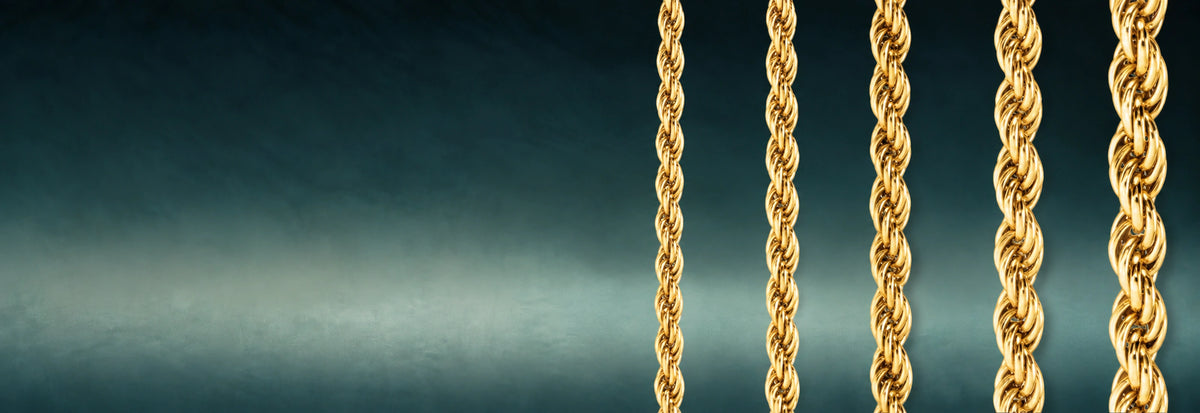 Yellow gold rope chains on a dark teal background