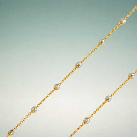 14K yellow gold bead chain showing smooth spherical gold beads in a continuous strand