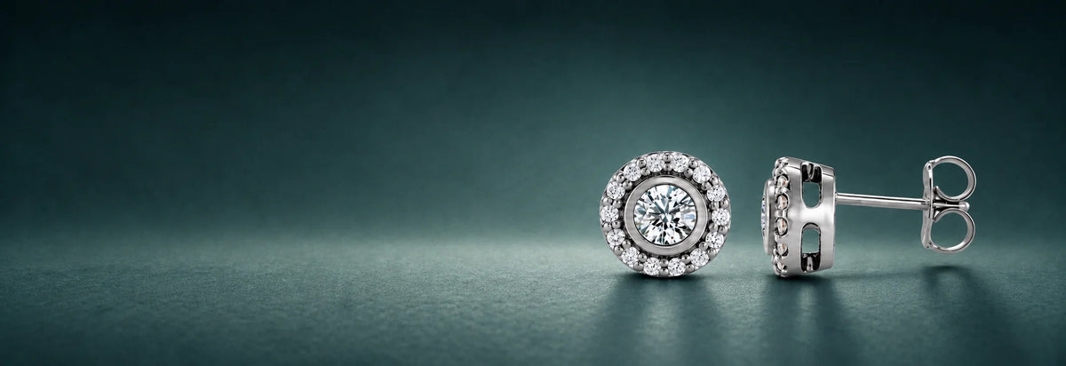 White gold diamond halo stud earrings on a dark teal background